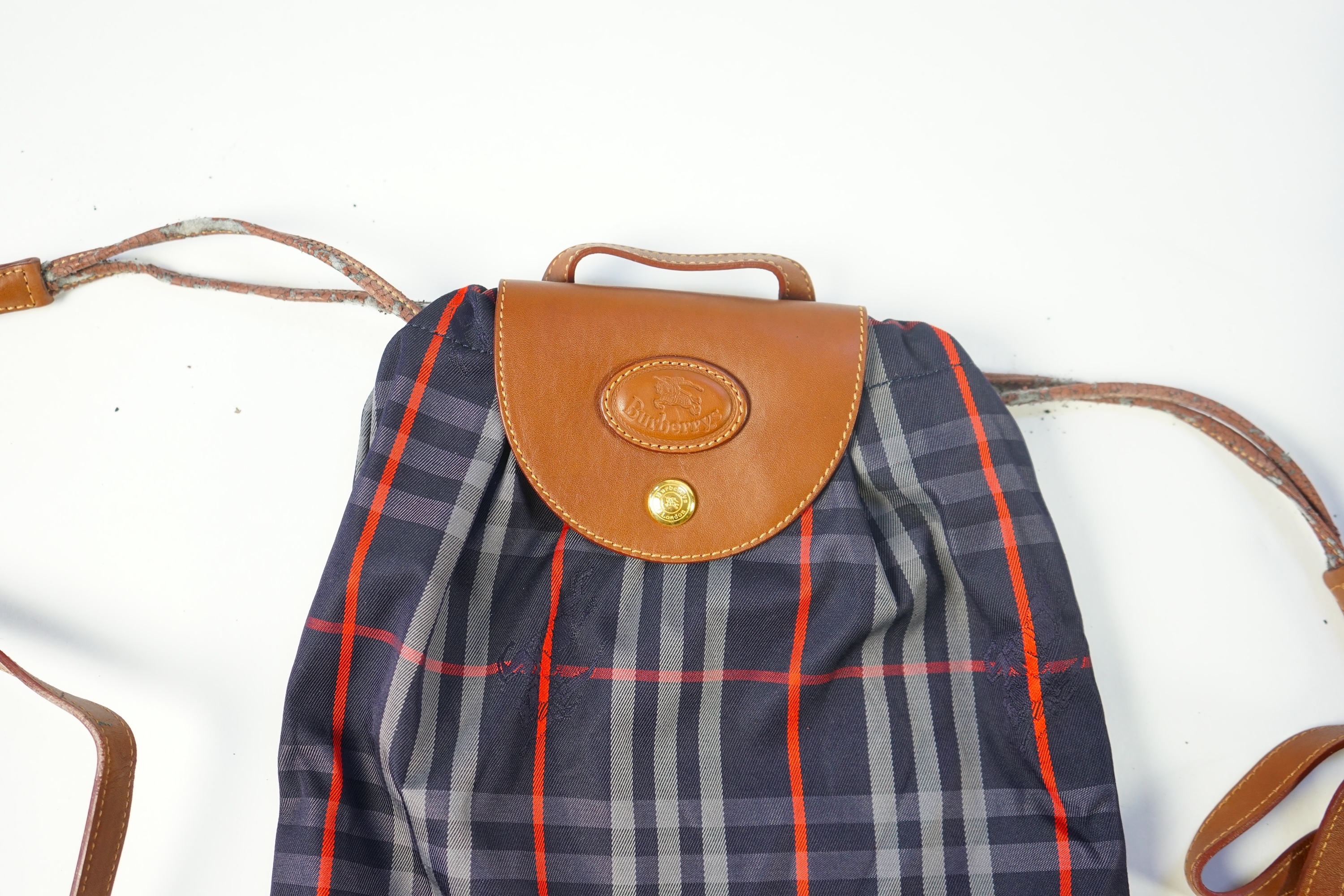 Two tartan canvas with leather trim Burberry bags, one backpack and one bucket bag